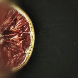 Close-up of strawberry over black background