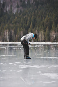 Full length of man jumping on lake