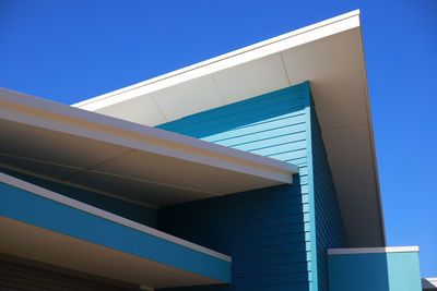 Low angle view of building against clear blue sky