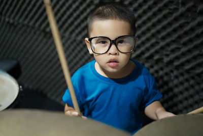 Portrait of boy playing drums
