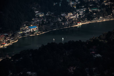 High angle view of illuminated city against sky at night