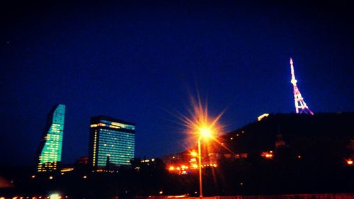 Low angle view of modern building against sky at night