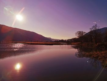 Scenic view of lake against sky during sunset