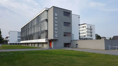 Exterior of building by field against sky