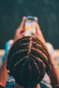 High angle view of young man using mobile phone at beach