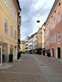 Street amidst buildings against sky in city