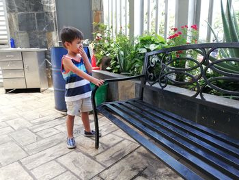 Full length side view of boy standing outdoors