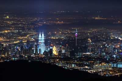 Mid distance view of illuminated petronas tower and kuala lumpur tower at night