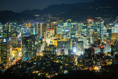 High angle view of illuminated city buildings at night