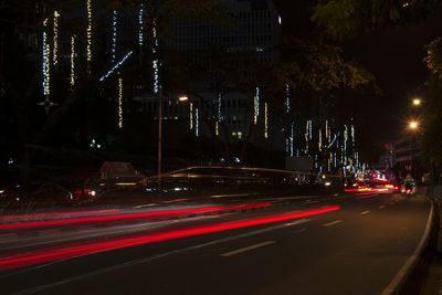 Light trails on road in city at night