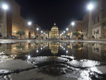 Reflection of buildings in city at night