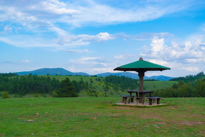 Gazebo on field against sky