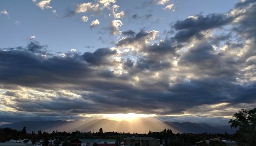 Sunlight streaming through clouds during sunset