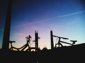 Low angle view of silhouette bridge against sky