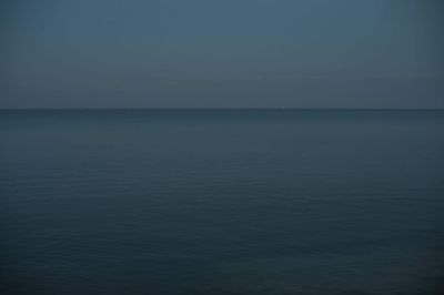 Scenic view of sea against clear sky at dusk