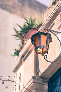 Low angle view of lantern hanging against building