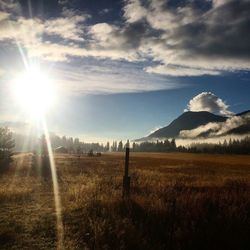 Scenic view of landscape against cloudy sky