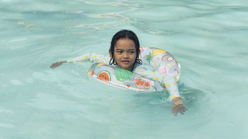 Portrait of boy swimming in lake