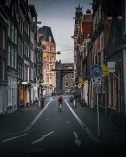 Road amidst buildings in city