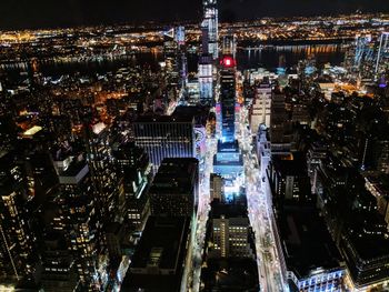 High angle view of city lit up at night