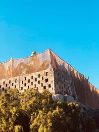 Low angle view of fort against blue sky