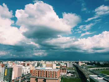 Cityscape against cloudy sky