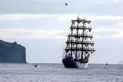 Ship sailing on sea against sky