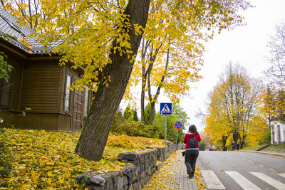 Young woman walking on the street in trakai, touristic scene, travel destination. lithuania