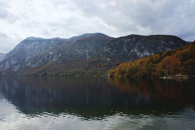 Autumn view of the beautiful bohinj lake with stunning transparent water against the alps mountains.