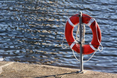 Red umbrella on wooden post at beach