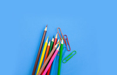 Close-up of multi colored pencils against blue background