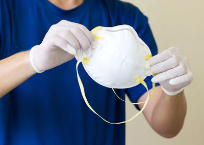 Close-up of man working against blue wall