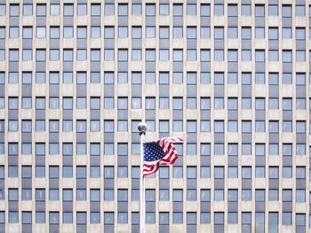 Low angle view of flag against blue sky