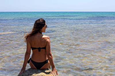 Full length of woman on beach against sky