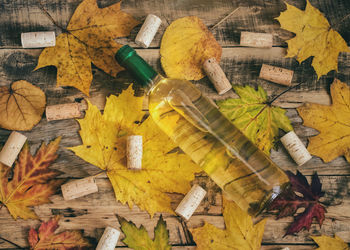 High angle view of yellow leaves on wooden table