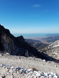 Scenic view of rocky mountains against blue sky