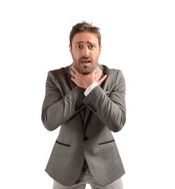 Portrait of man standing against white background