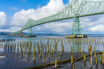 A view of the astoia-megler bridge that spans the columbia river. old pilings in the forground.