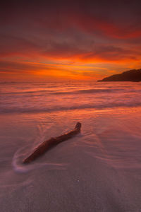 Close-up of sea against sky at sunset