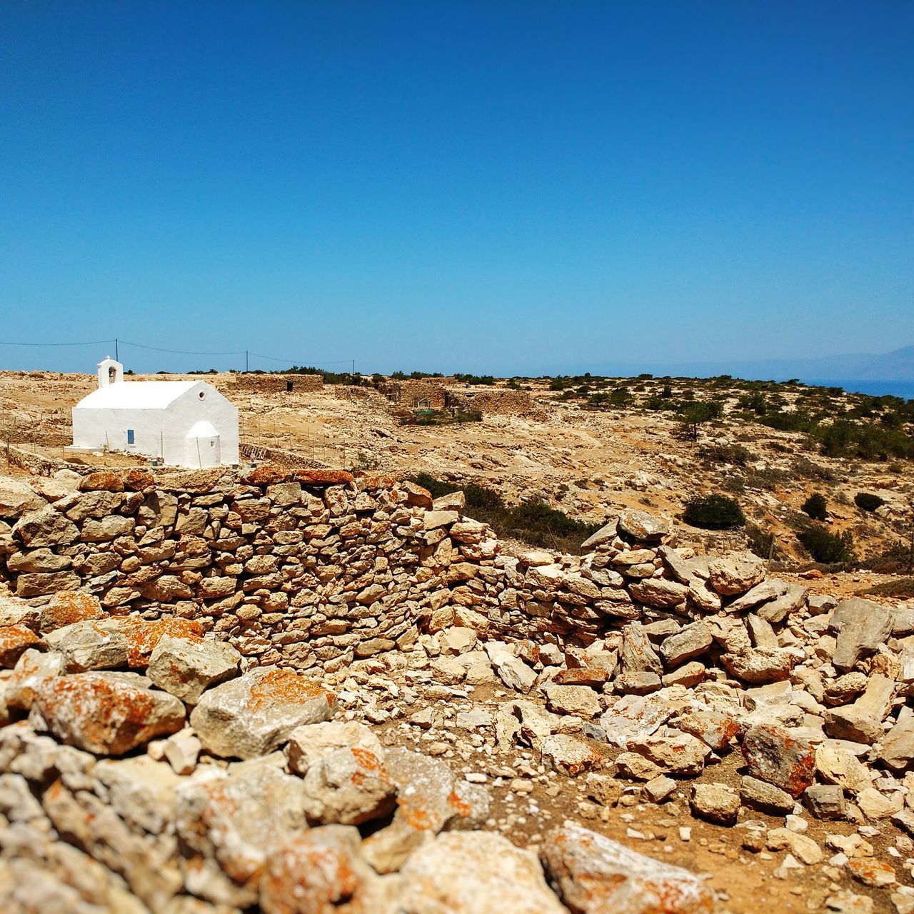 SURFACE LEVEL OF ROCKS AGAINST CLEAR SKY