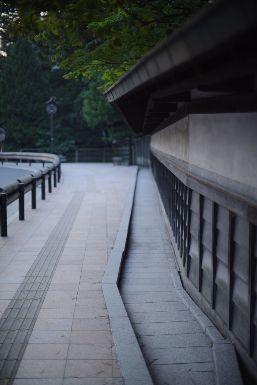 architecture, built structure, the way forward, no people, direction, railing, footpath, nature, day, tree, building exterior, outdoors, empty, focus on foreground, absence, wood - material, plant, connection, sidewalk, diminishing perspective