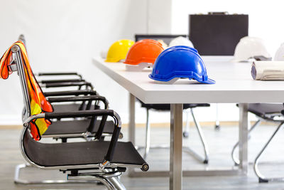 Close-up of empty chairs and tables