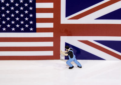 Low angle view of man and flag on white wall