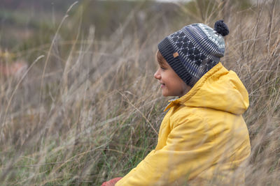 Side view of boy looking away on field