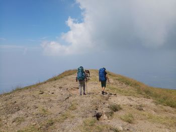 Rear view of hikers on mountain