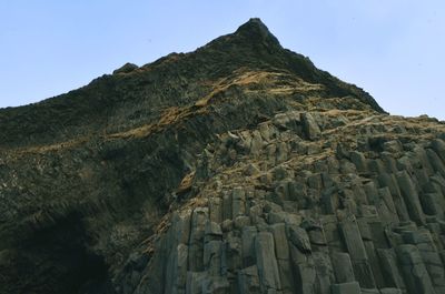 Low angle view of rock formation against sky