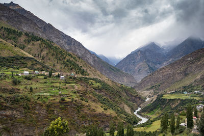 Panoramic shot of countryside landscape against mountain range