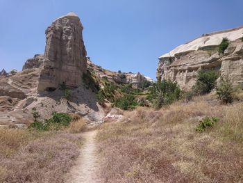 Rock formations against clear blue sky