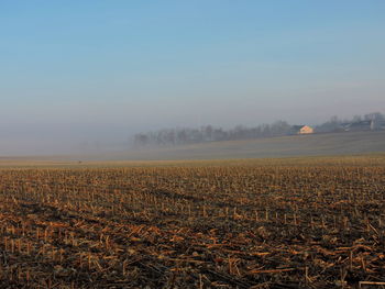 Scenic view of field against sky during foggy weather