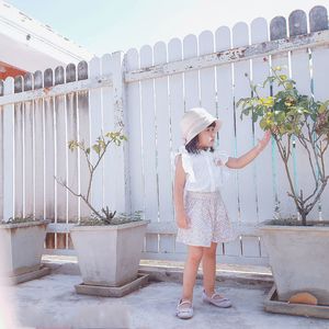 Full length of girl standing by plants